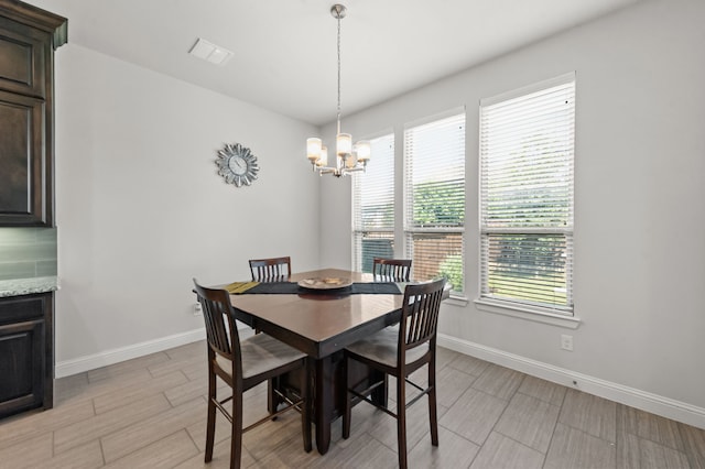 dining space with a chandelier