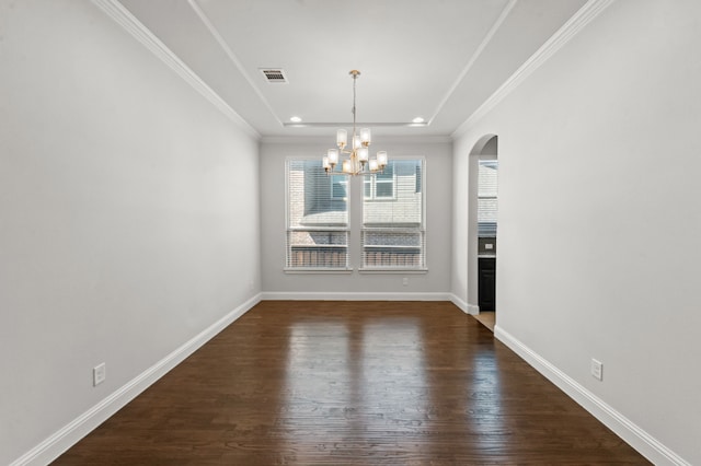 unfurnished dining area featuring dark wood-type flooring, ornamental molding, and an inviting chandelier