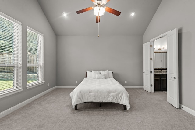 bedroom with vaulted ceiling, ceiling fan, light carpet, and connected bathroom