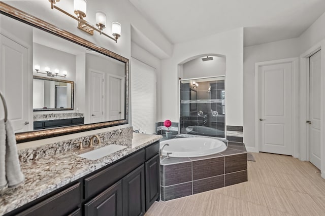 bathroom with vanity, separate shower and tub, and tile patterned flooring