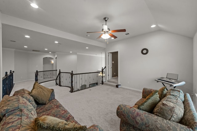 living room featuring ceiling fan, crown molding, lofted ceiling, and light carpet