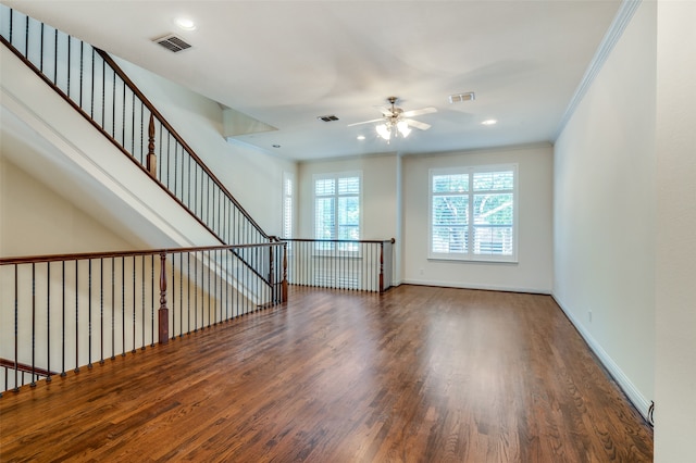 empty room with crown molding, ceiling fan, and wood-type flooring