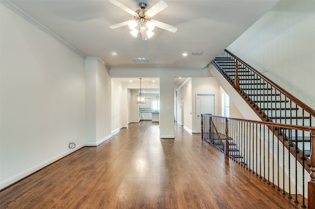 interior space with ceiling fan with notable chandelier and wood-type flooring