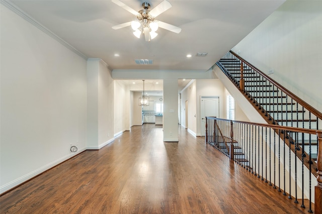 interior space with ornamental molding and dark hardwood / wood-style floors