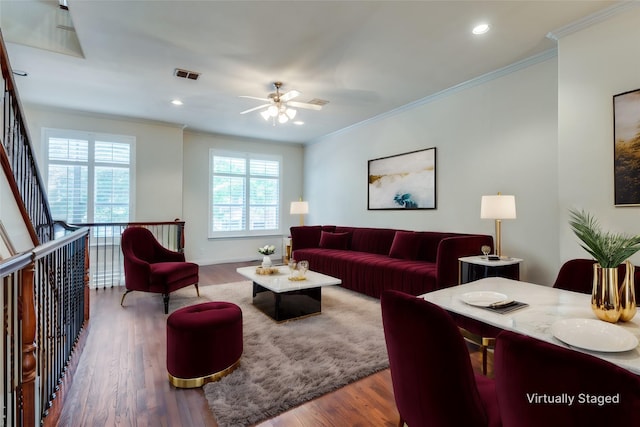 living room featuring ornamental molding, hardwood / wood-style floors, and ceiling fan