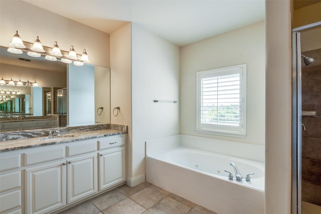 bathroom featuring tile patterned flooring, shower with separate bathtub, and vanity