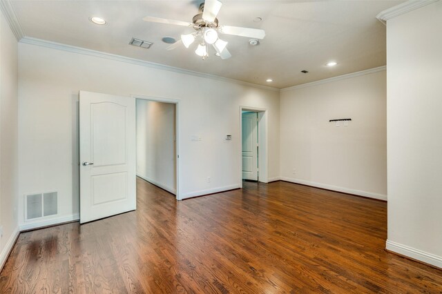 empty room with crown molding, dark hardwood / wood-style floors, and ceiling fan