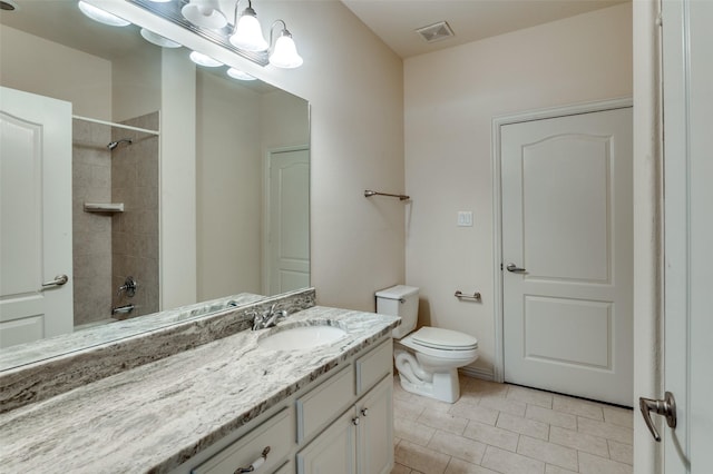 full bathroom featuring tile patterned floors, vanity, toilet, and tiled shower / bath combo