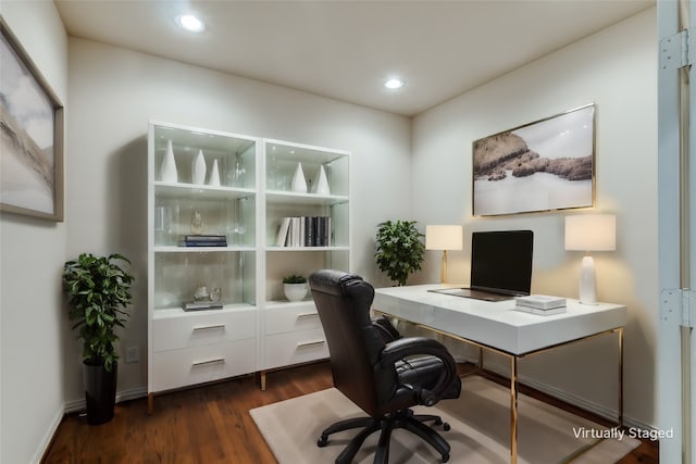 home office with dark hardwood / wood-style flooring