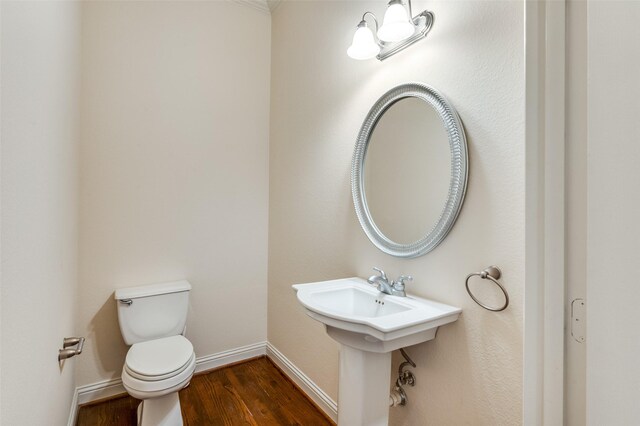 bathroom featuring wood-type flooring and toilet