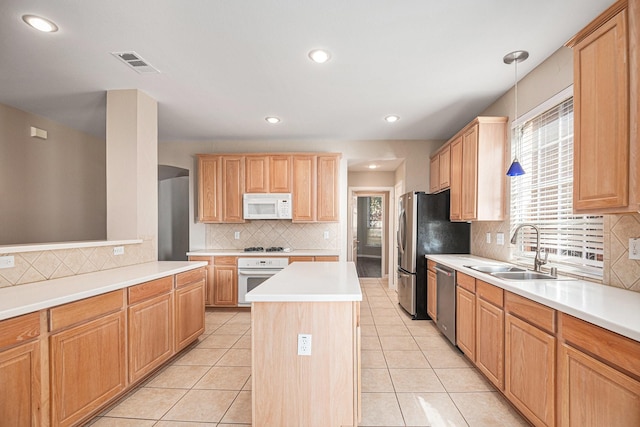 kitchen featuring sink, a kitchen island, pendant lighting, light tile patterned flooring, and appliances with stainless steel finishes