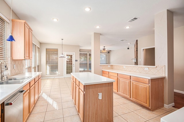 kitchen with dishwasher, a kitchen island, decorative backsplash, and sink