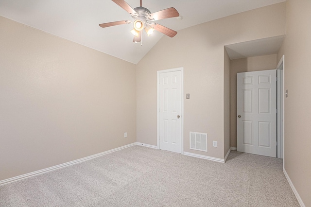 unfurnished bedroom with ceiling fan, light colored carpet, and vaulted ceiling