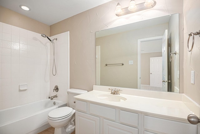 full bathroom with vanity, tiled shower / bath combo, and toilet