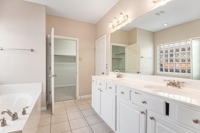 bathroom with vanity, tile patterned floors, and a bathing tub