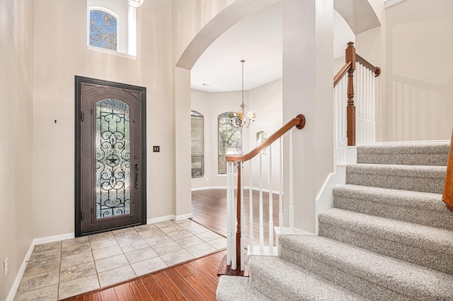 foyer featuring a chandelier, light wood-type flooring, and a wealth of natural light