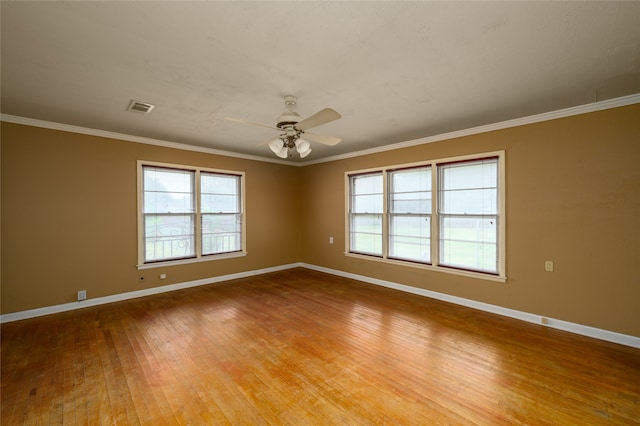 spare room with a healthy amount of sunlight, crown molding, ceiling fan, and light hardwood / wood-style floors