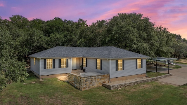 view of front of house featuring a carport and a lawn