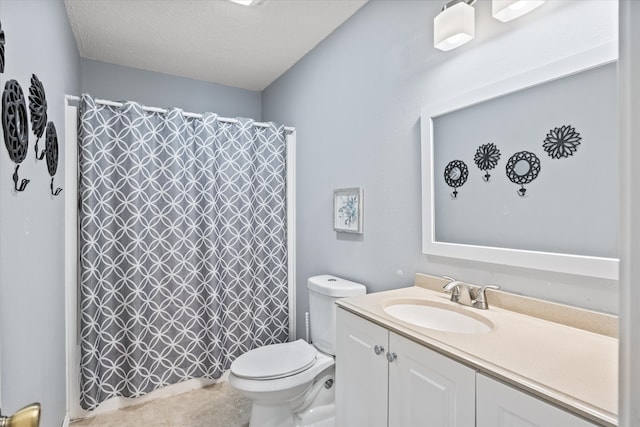 bathroom with vanity, a textured ceiling, and toilet