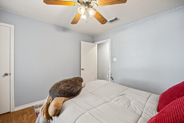 bedroom with ceiling fan and hardwood / wood-style floors