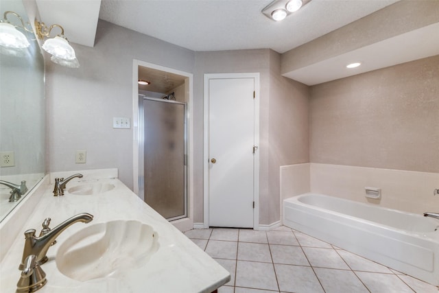 bathroom with tile patterned flooring, vanity, a textured ceiling, and independent shower and bath