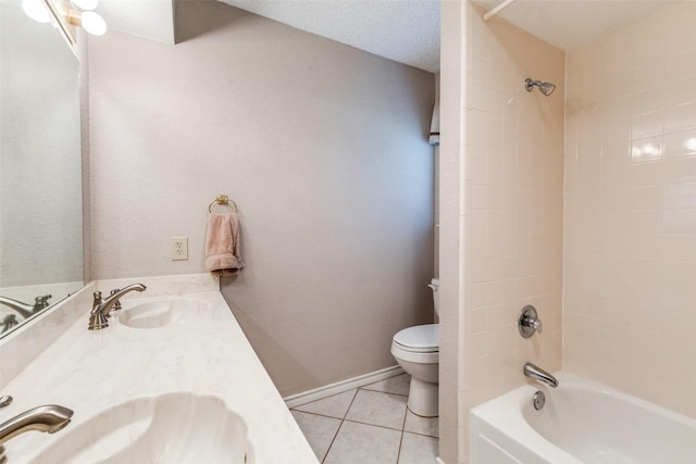 full bathroom featuring tile patterned floors, vanity, a textured ceiling, toilet, and tiled shower / bath