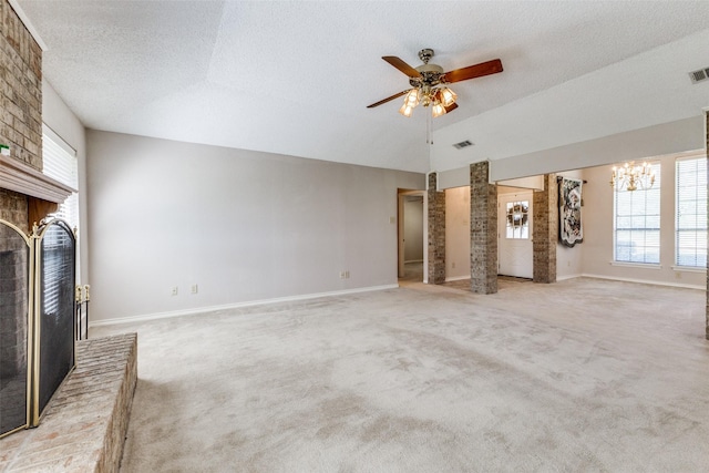 unfurnished living room with a textured ceiling, carpet, vaulted ceiling, and ceiling fan with notable chandelier