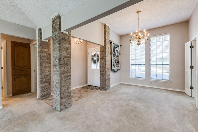 interior space with a textured ceiling and an inviting chandelier