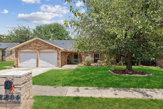 view of front of house with a garage and a front lawn