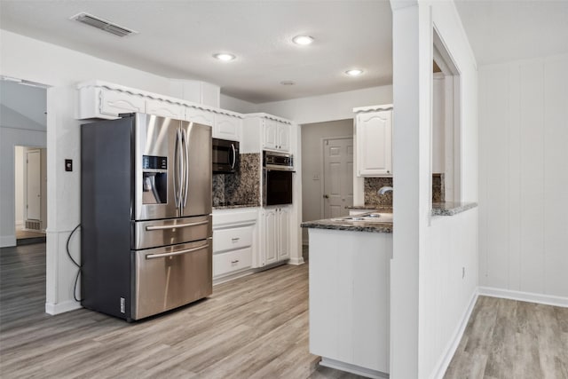 kitchen featuring stainless steel refrigerator with ice dispenser, sink, white cabinetry, light hardwood / wood-style flooring, and wall oven