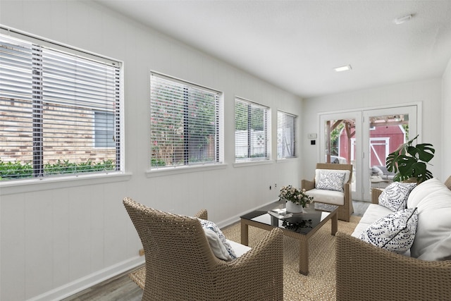 living room featuring plenty of natural light, french doors, and wood-type flooring