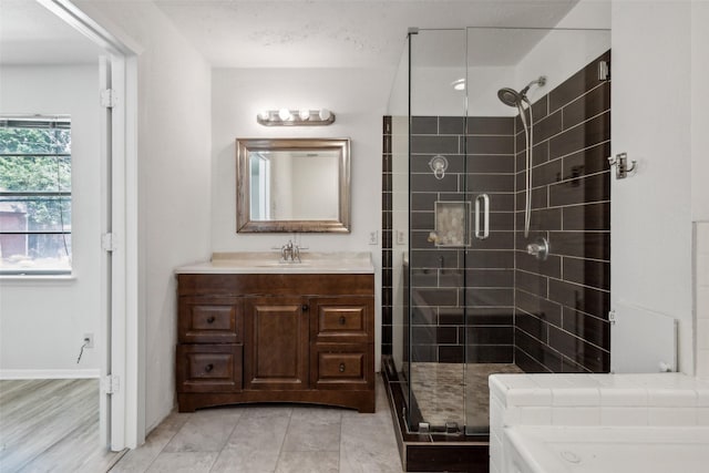 bathroom featuring vanity and a shower with shower door