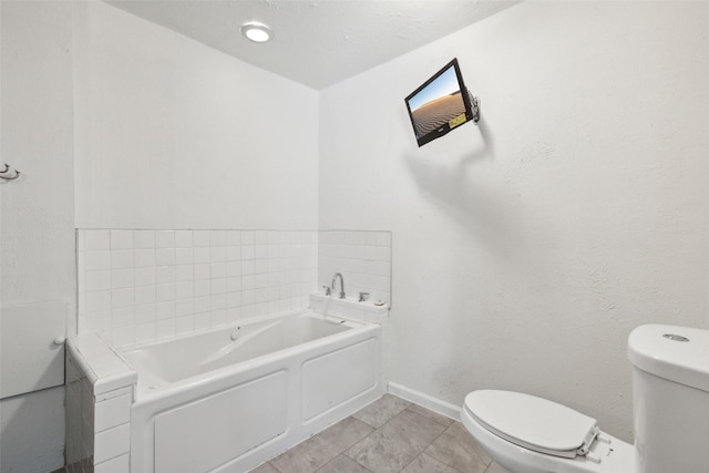 bathroom with tile patterned flooring, a bathing tub, and toilet