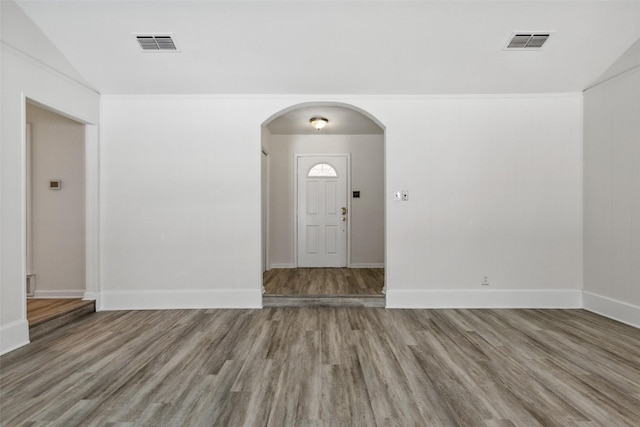 foyer featuring hardwood / wood-style floors and vaulted ceiling