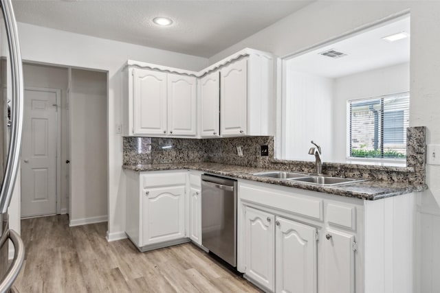 kitchen featuring sink, light hardwood / wood-style flooring, white cabinets, and appliances with stainless steel finishes