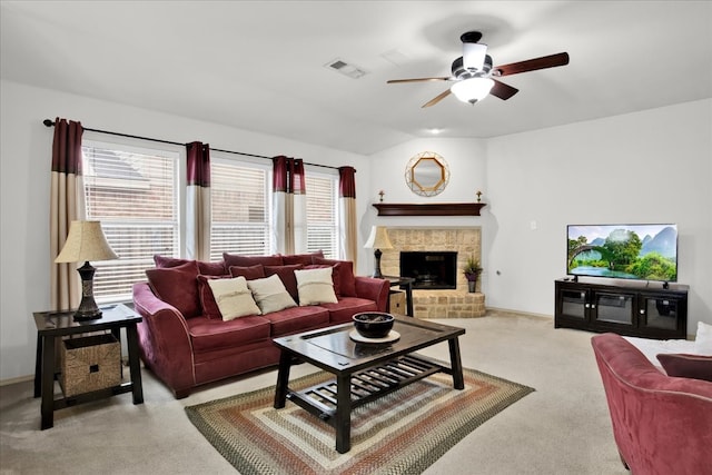 living room featuring light colored carpet, a brick fireplace, and ceiling fan