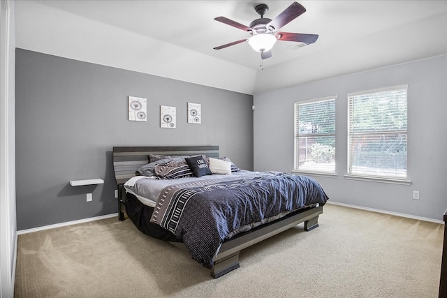 bedroom with vaulted ceiling, ceiling fan, and carpet flooring