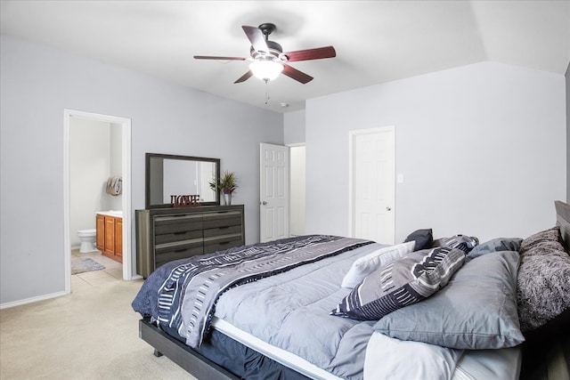 bedroom featuring lofted ceiling, light colored carpet, connected bathroom, and ceiling fan