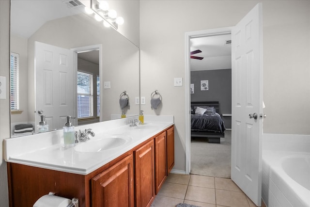 bathroom featuring ceiling fan, tile patterned floors, tiled bath, vaulted ceiling, and vanity