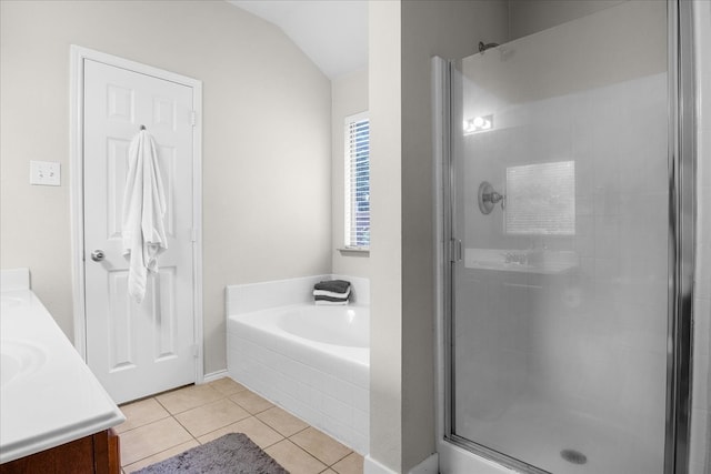 bathroom with lofted ceiling, tile patterned floors, plus walk in shower, and vanity