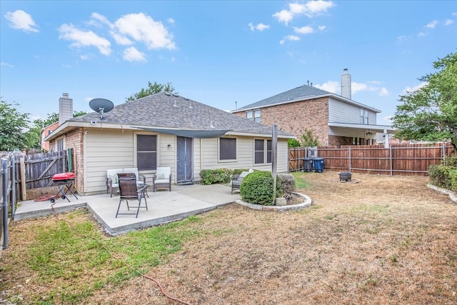 rear view of property featuring a patio and a lawn