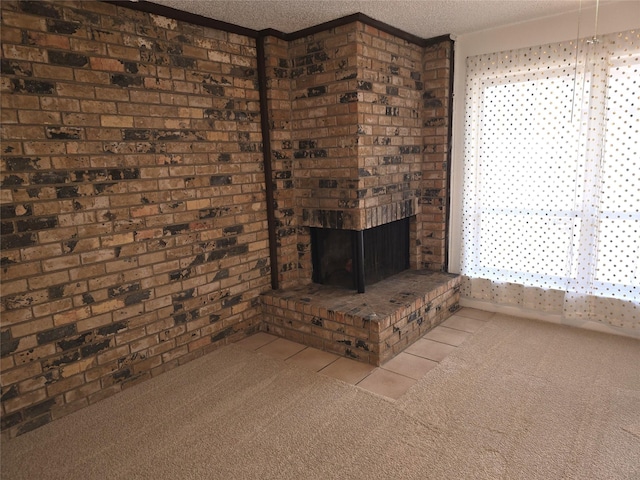 unfurnished living room featuring a brick fireplace, a textured ceiling, and light carpet