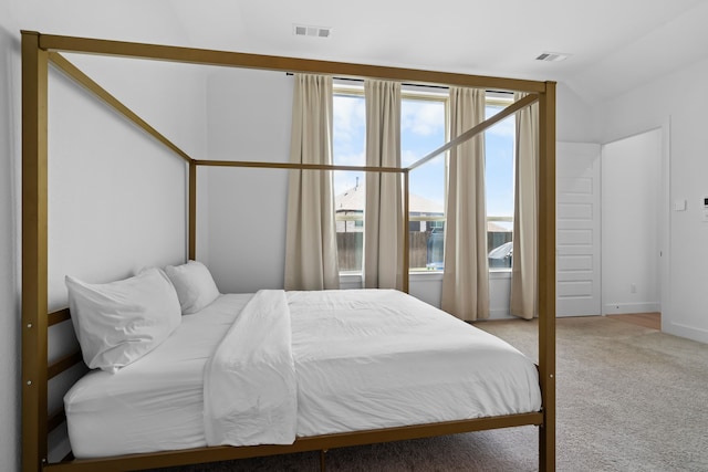 bedroom featuring lofted ceiling and carpet floors