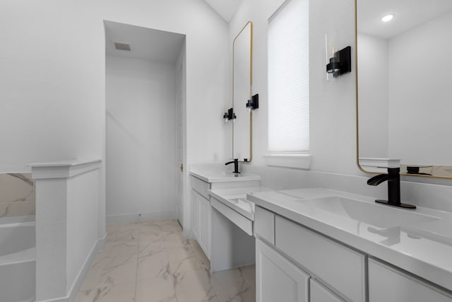 bathroom with a tub to relax in, vanity, and lofted ceiling