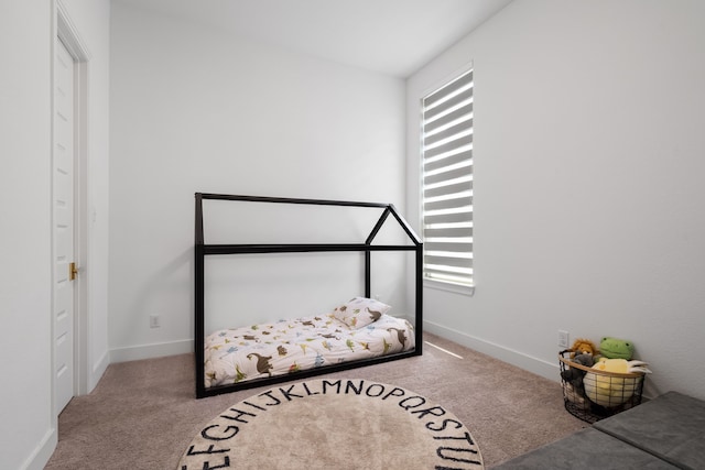 bedroom featuring lofted ceiling, carpet floors, and multiple windows