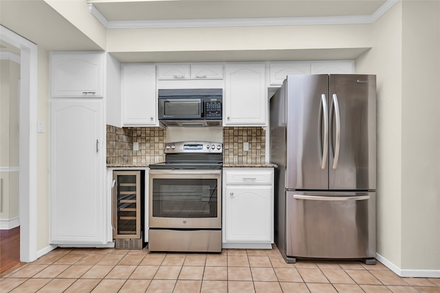 kitchen with white cabinetry, light tile patterned floors, beverage cooler, and appliances with stainless steel finishes