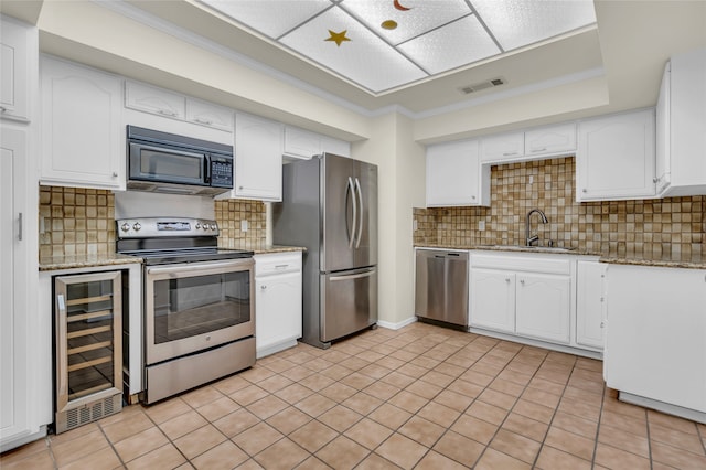 kitchen featuring sink, stainless steel appliances, white cabinets, and wine cooler