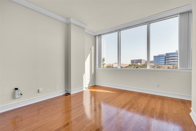 unfurnished room featuring crown molding and light hardwood / wood-style flooring