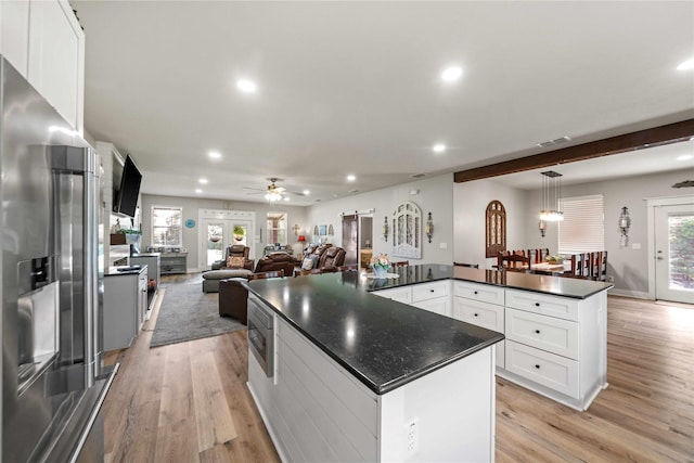 kitchen featuring pendant lighting, a center island, light hardwood / wood-style floors, white cabinets, and high end refrigerator