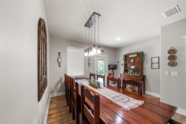 dining room with dark hardwood / wood-style flooring